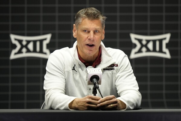 Oklahoma coach Porter Moser speaks to the media during the NCAA college Big 12 men's basketball media day Wednesday, Oct. 18, 2023, in Kansas City, Mo. (AP Photo/Charlie Riedel)