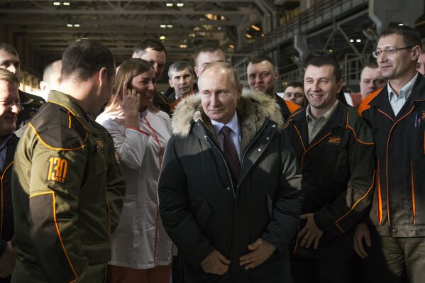
              FILE - In this Tuesday, March 6, 2018 file photo, Russian President Vladimir Putin listens to employees of Uralvagonzavod factory in Nizhny Tagil, Russia. President Vladimir Putin seems self-assured and confident of victory in the election on Sunday, March 18, even as the Kremlin works hard to bolster turnout to make the result as impressive as possible. Unlike the 2012 balloting when he often looked tense and nervous amid massive protests of his rule, Putin faces no such threats this time, despite an anemic economy and spiraling tensions with the West. (AP Photo/Alexander Zemlianichenko, File)
            