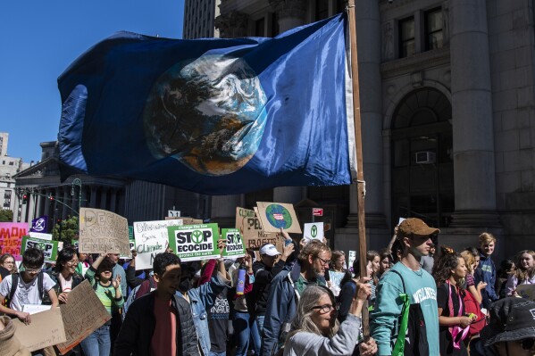 FILE - Activists gather and walk through lower Manhattan for the Global Climate Strike protests, Sept. 23, 2022, in New York. The annual Climate Week, which coincides with the U.N. General Assembly, kicks off Sunday, Sept. 17, 2023, with tens of thousands of people expected in the “March to End Fossil Fuels” Manhattan rally, one of hundreds of worldwide protests. (AP Photo/Brittainy Newman, File)