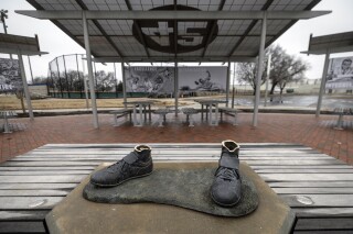 FILE - Bronze feet are left behind after the statue of legendary baseball pioneer Jackie Robinson was stolen from a park in Wichita, Kan., early Jan. 25, 2024. A 45-year-old man has pleaded guilty in the theft of the statue that was cut off at the ankles and found days later smoldering in a trash can in a city park in Kansas. (Travis Heying/The Wichita Eagle via AP, File)