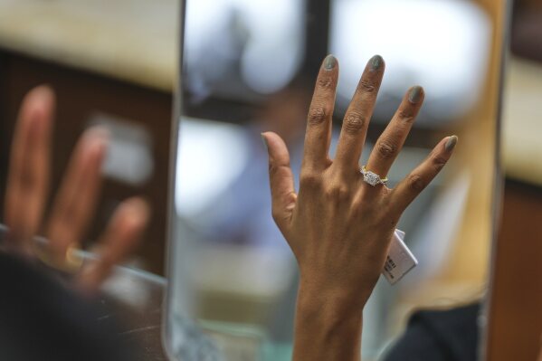 A woman tries on a diamond ring at a jewelry shop in Ahmedabad, India, on April 14, 2025. (AP Photo/Ajit Solanki)