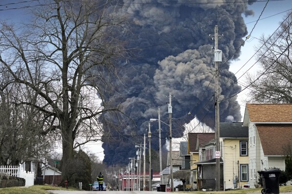 FILE - A black plume rises over East Palestine, Ohio, as a result of the controlled detonation of a portion of the derailed Norfolk Southern trains Monday, Feb. 6, 2023. On Tuesday, April 9, 2024, Norfolk Southern has agreed to pay $600 million in a class-action lawsuit settlement related to a fiery train derailment in February 2023 in eastern Ohio. (AP Photo/Gene J. Puskar, File)