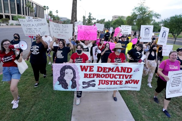 FILE - Thousands of protesters march around the Arizona Capitol in protest after the Supreme Court decision to overturn the landmark Roe v. Wade abortion decision Friday, June 24, 2022, in Phoenix. An Arizona Supreme Court ruling, Tuesday, April 9, 2024, allowing enforcement of an abortion ban is the latest action to elevate abortion as a key political issue this year. (AP Photo/Ross D. Franklin, File)