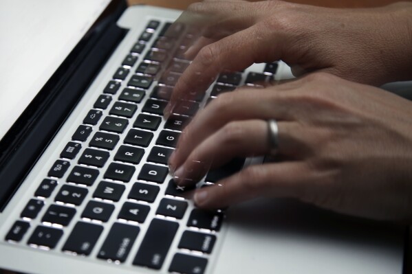 This June 19, 2017 file photo shows a person working on a laptop in North Andover, Mass. (AP Photo/Elise Amendola, File)