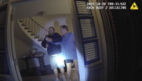 FILE - In this image taken from San Francisco Police Department body-camera video, the husband of former U.S. House Speaker Nancy Pelosi, Paul Pelosi, right, fights for control of a hammer with his assailant David DePape during a brutal attack in the couple's San Francisco home on Oct. 28, 2022. Opening statements are scheduled for Thursday, Nov. 8, 2023, in the federal trial of the man accused of breaking into former House Speaker Nancy Pelosi's San Francisco home seeking to kidnap her and bludgeoning her husband with a hammer. (San Francisco Police Department via 麻豆传媒app, File)