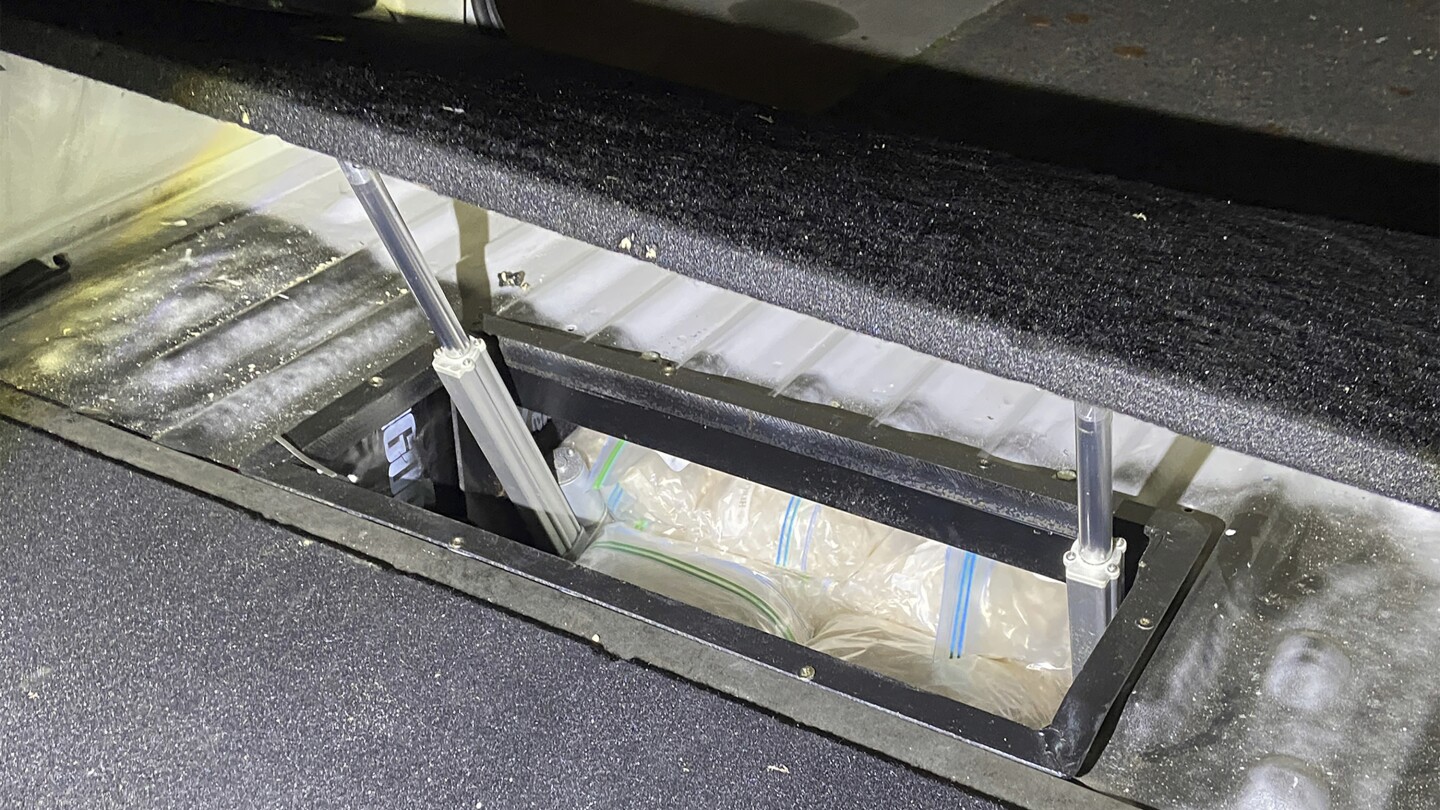 In this undated photo provided by the Australian Federal Police, illicit drugs are found in a concealed compartment in a vehicle after police have rev