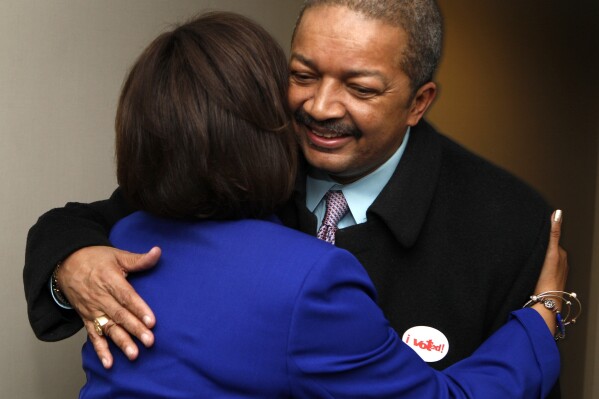 FILE - Democrat Robin Kelly, left, greets her husband, Dr. Nathaniel Horn, in her suite as she awaits the outcome of the special election in Illinois' 2nd Congressional District, April 9, 2013, in Matteson, Ill. Dr. Nathaniel Horn, the husband of the U.S. representative from Illinois died Friday, Aug. 18, 2023, according to a statement. Horn was 68. No cause of death was given. (AP Photo/John Smierciak, File)