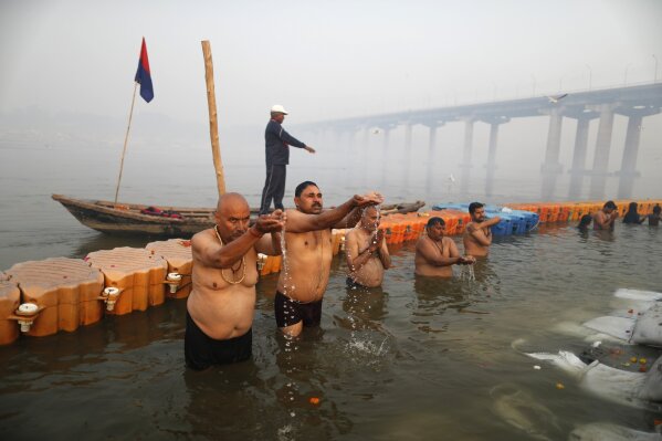 Devotees pray and take holy dips at Sangam, during Magh Mela festival, in Prayagraj, India. Friday, Feb. 19, 2021. Millions of people have joined a 45-day long Hindu bathing festival in this northern Indian city, where devotees take a holy dip at Sangam, the sacred confluence of the rivers Ganga, Yamuna and the mythical Saraswati. Here, they bathe on certain days considered to be auspicious in the belief that they be cleansed of all sins. (AP Photo/Rajesh Kumar Singh)