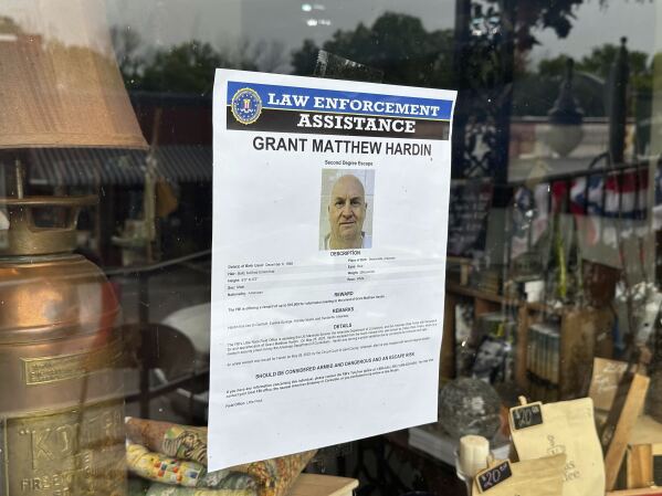 A flyer searching for Grant Hardin is hanging from the glass of business at ARK (AP Photo/Nicholas Ingram) in downtown Calico Rock on Thursday, May 29, 2025.