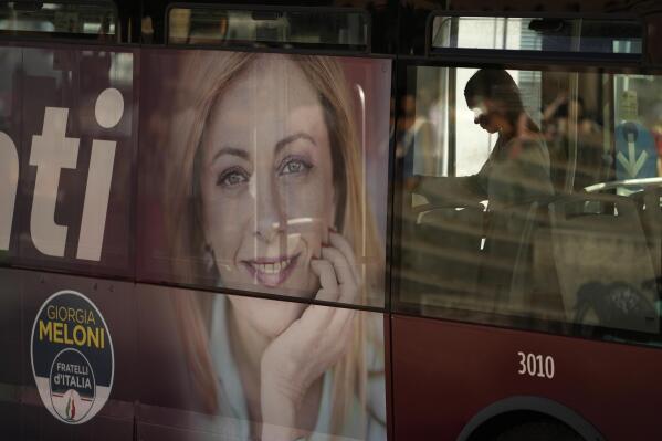 A poster of Italy's candidate premier Giorgia Meloni is seen on the side of a bus, in Rome, Friday, Sept. 16, 2022. Italians will vote on Sunday in what is being billed as a crucial election as Europe reels from repercussions of Russia's war in Ukraine. (AP Photo/Alessandra Tarantino)