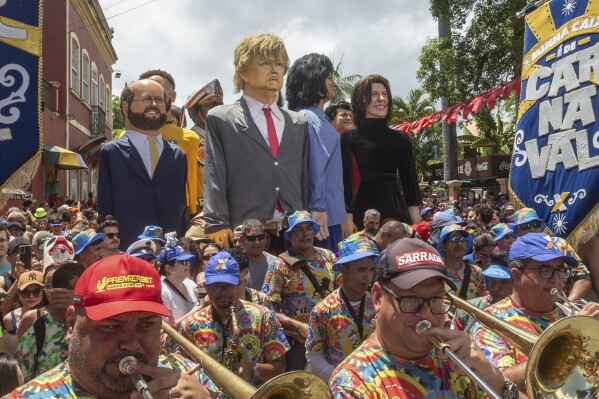A large puppet of U.S. President Donald Trump is paraded during Carnival celebrations alongside other puppets of local politicians and artists in Olinda, Pernambuco state, Brazil, Monday, March 3, 2025. (AP Photo/Andre Mantelli)