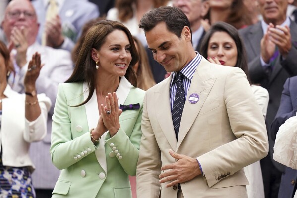 Britain's Kate, Princess of Wales, left, shares a word with tennis champion Roger Federer in the royal box, on day two of the Wimbledon tennis championships in London, Tuesday, July 4, 2023. (Adam Davy/PA via AP)