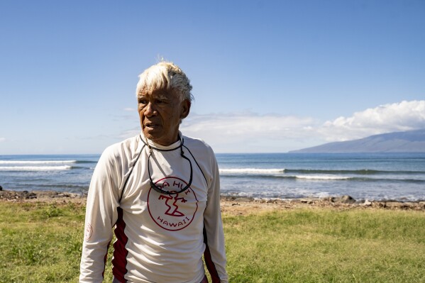 Abraham "Snake" Ah Hee, one of the first crew members of Hokulea - the Polynesian double-hulled voyaging canoe, is pictured at Launiupoko Beach Park on Friday, Feb. 23, 2024, in Lahaina, Hawaii. Ah Hee said he has noticed there has been less limu (seaweed) after last year's fire. (AP Photo/Mengshin Lin)