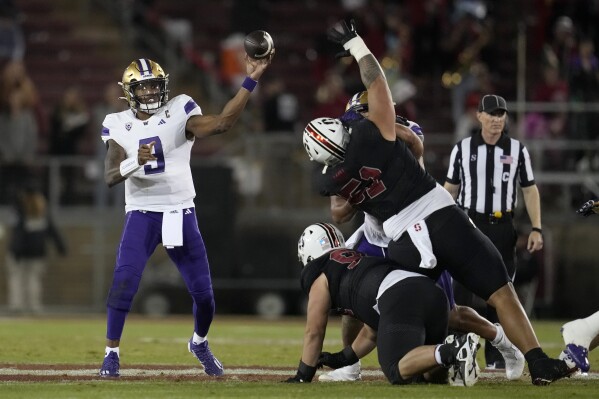 Washington quarterback Michael Penix Jr. (9) throws a pass against Stanford during the second half of an NCAA college football game in Stanford, Calif., Saturday, Oct. 28, 2023. (AP Photo/Jeff Chiu)