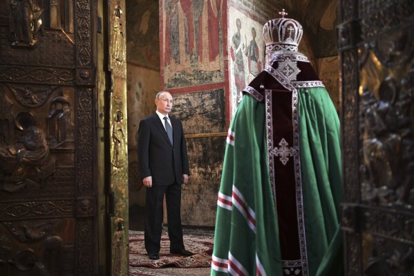 Russian President Vladimir Putin attends a service held by Russian Orthodox Patriarch Krill, right, in the Annunciation Cathedral after the inauguration ceremony in the Kremlin in Moscow, Russia, on Monday, May 7, 2018. Putin took the oath of office for his fourth term as Russian president on Monday and promised to pursue an economic agenda that would boost living standards across the country. (Alexei Nikolsky, Sputnik, Kremlin Pool Photo via AP)