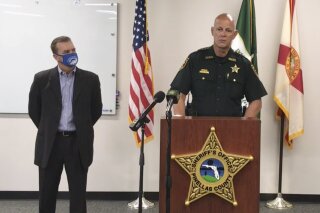 In this screen shot from a YouTube video posted by the Pinellas County Sheriff's Office, Pinellas County Sheriff Bob Gualtieri speaks during a news conference as Oldsmar, Fla., Mayor Eric Seidel, left, listens, Monday, Feb. 8, 2021, in Oldsmar, Fla. Authorities say a hacker gained access to Oldsmar's water treatment plant in an unsuccessful attempt to taint the water supply with a caustic chemical. (Pinellas County Sheriff's Office via AP)