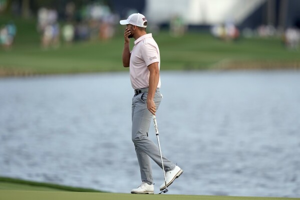 Wyndham Clark reacts to missing a birdie putt on the 18th green during the final round of The Players Championship golf tournament Sunday, March 17, 2024, in Ponte Vedra Beach, Fla. (AP Photo/Lynne Sladky)