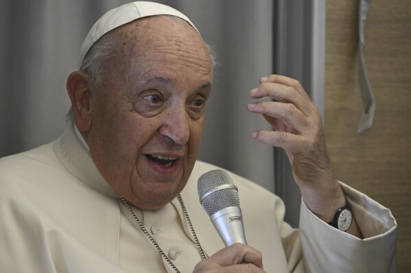 Pope Francis talks to reporters during the return flight from Ulaanbaatar, Mongolia, Monday, Sept. 4, 2023, at the end of a historic four-day visit to a region where the Holy See has long sought to make inroads. (Ciro Fusco/ANSA via AP, Pool)