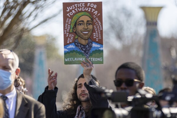 Noah Gringi holds a sign at a press conference for Manuel Esteban Paez Terán in Decatur, Ga., Feb. 6, 2023. (Arvin Temkar/Atlanta Journal-Constitution via AP, File)