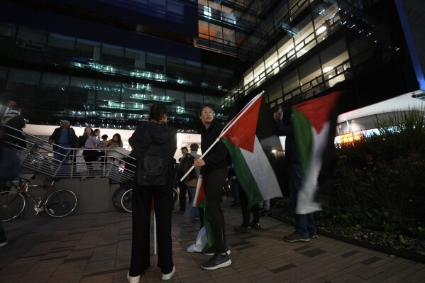 Anti-Israel protesters hold Palestinian flags during a rally outside the Israeli embassy in Bogota, Colombia, Tuesday, Oct. 10, 2023. (AP Photo/Fernando Vergara)