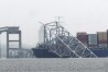 A container ship rests against the wreckage of the Francis Scott Key Bridge on Thursday, March 28, 2024, in Baltimore, Md. After days of searching through murky water for the workers missing after the bridge collapsed, officials are turning their attention Thursday to what promises to be a massive salvage operation. (AP Photo/Matt Rourke)