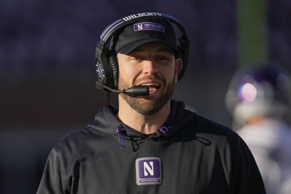 Northwestern head coach David Braun walks the sideline during the first half of an NCAA college football game against Illinois, Saturday, Nov. 25, 2023, in Champaign, Ill. (AP Photo/Erin Hooley)