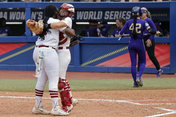 Stanford pitcher NiJaree Canady, left, and catcher Aly Kaneshiro celebrate as Washington's Jadelyn Allchin (42) leaves the field after an NCAA softball Women's College World Series game Sunday, June 4, 2023, in Oklahoma City. (AP Photo/Nate Billings)