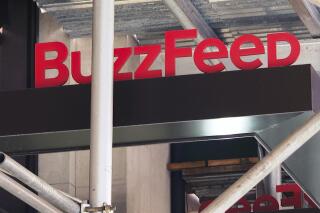 FILE - The entrance to BuzzFeed in New York is seen on Nov. 19, 2020. Pulitzer prize winning digital media company BuzzFeed is cutting about 15% of its staff, according to multiple media reports. In a memo sent to staff, co-founder and CEO Jonah Peretti said that the New York company was going to start the process of shutting down its news division, and that cuts would also occur across its business, content, tech and administrative teams. (AP Photo/Ted Shaffrey, File)