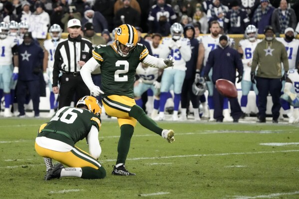 FILE -Green Bay Packers' Pat O'Donnell (16) holds as place kicker Mason Crosby (2) kicks a field goal in overtime of an NFL football game against the Dallas Cowboys Sunday, Nov. 13, 2022, in Green Bay, Wis. The Los Angeles Rams have signed longtime Green Bay kicker Mason Crosby to their practice squad. The 39-year-old Crosby joined the Rams on Wednesday, Dec. 6, 2023. The move likely indicates Crosby will soon be the third kicker to appear in a game for Los Angeles this season, given incumbent Lucas Havrisik's recent struggles. (APPhoto/Morry Gash, File)