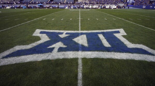 FILE - The logo for the Big 12 Conference has been applied to the field for an NCAA college football game between Sam Houston State and BYU on Saturday, Sept. 2, 2023, in Provo, Utah. The NCAA and the nation's five biggest conferences have agreed to pay nearly $2.8 billion to settle a host of antitrust claims,a monumental decision that sets the stage for a groundbreaking revenue-sharing model that could start directing millions of dollars directly to athletes as soon as the 2025 fall semester. (AP Photo/Rick Bowmer, File)
