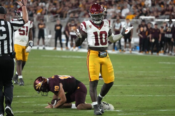 Southern California defensive end Jamil Muhammad (10) reacts after sacking Arizona State quarterback Drew Pyne (10) in the second half during an NCAA college football game, Saturday, Sept. 23, 2023, in Tempe, Ariz. Southern California won 42-28. (AP Photo/Rick Scuteri)