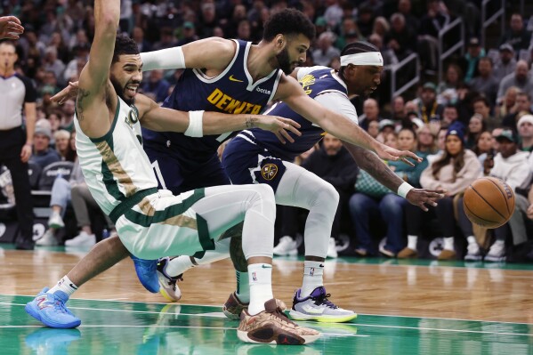 Denver Nuggets' Jamal Murray, center, fouls Boston Celtics' Jayson Tatum, left, during the first half of an NBA basketball game Friday, Jan 19, 2024, in Boston. (AP Photo/Michael Dwyer)