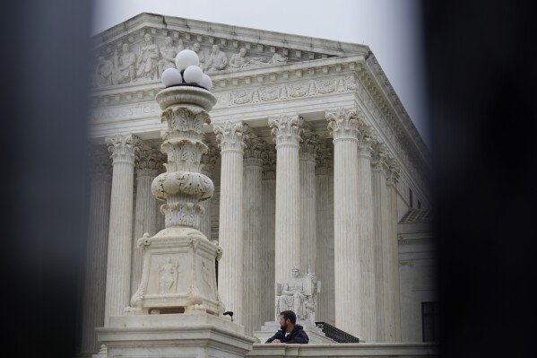 FILE - The U.S. Supreme Court is seen through anti-scaling fence surrounding the Court, Friday, May 6, 2022, in Washington. When Roe v. Wade was first overturned by the U.S. Supreme Court in 2022, proponents insisted it would mostly impact those seeking abortions to end an unwanted pregnancies. But that hasn’t been the case. Women who never intended to end their pregnancies have nearly died because they couldn’t get emergency treatment. Miscarriage care has been delayed. Routine reproductive medical care has dried up in states with strict bans. And fertility treatments were temporarily paused in Alabama. As that fallout grows, so do the opportunities for President Joe Biden and other Democrats eager to capitalize on the issue. (AP Photo/Mariam Zuhaib, File)