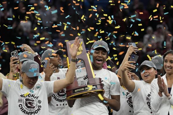 South Carolina's Aliyah Boston holds the trophy after a college basketball game in the final round of the Women's Final Four NCAA tournament against UConn Sunday, April 3, 2022, in Minneapolis. South Carolina won 64-49 to win the championship. (AP Photo/Eric Gay)