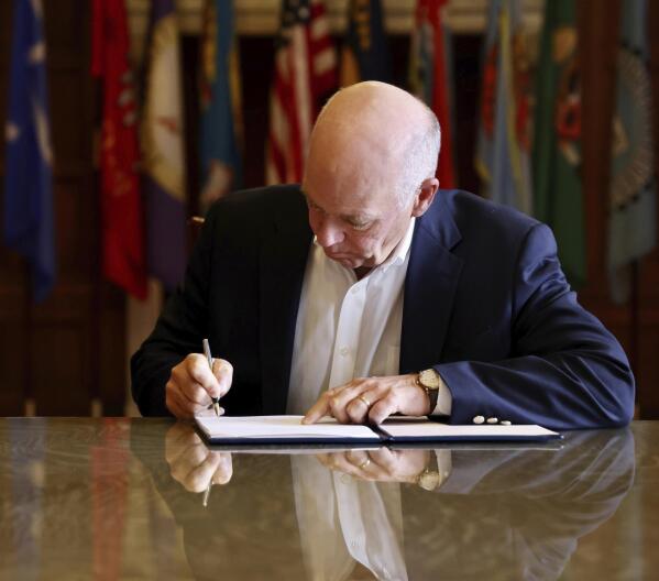 FILE - In this photo provided by the Montana Governor's Office, Republican Gov. Greg Gianforte signs a law banning TikTok in the state, May 17, 2023, in Helena, Mont. TikTok, Inc., filed a lawsuit Monday, May 22, 2023, seeking to overturn Montana's first-in-the-nation ban on the video sharing app, arguing the law is an unconstitutional violation of free speech rights and is based on “unfounded speculation” that the Chinese government could access users' data. (Garrett Turner/Montana Governor's Office via AP, File)