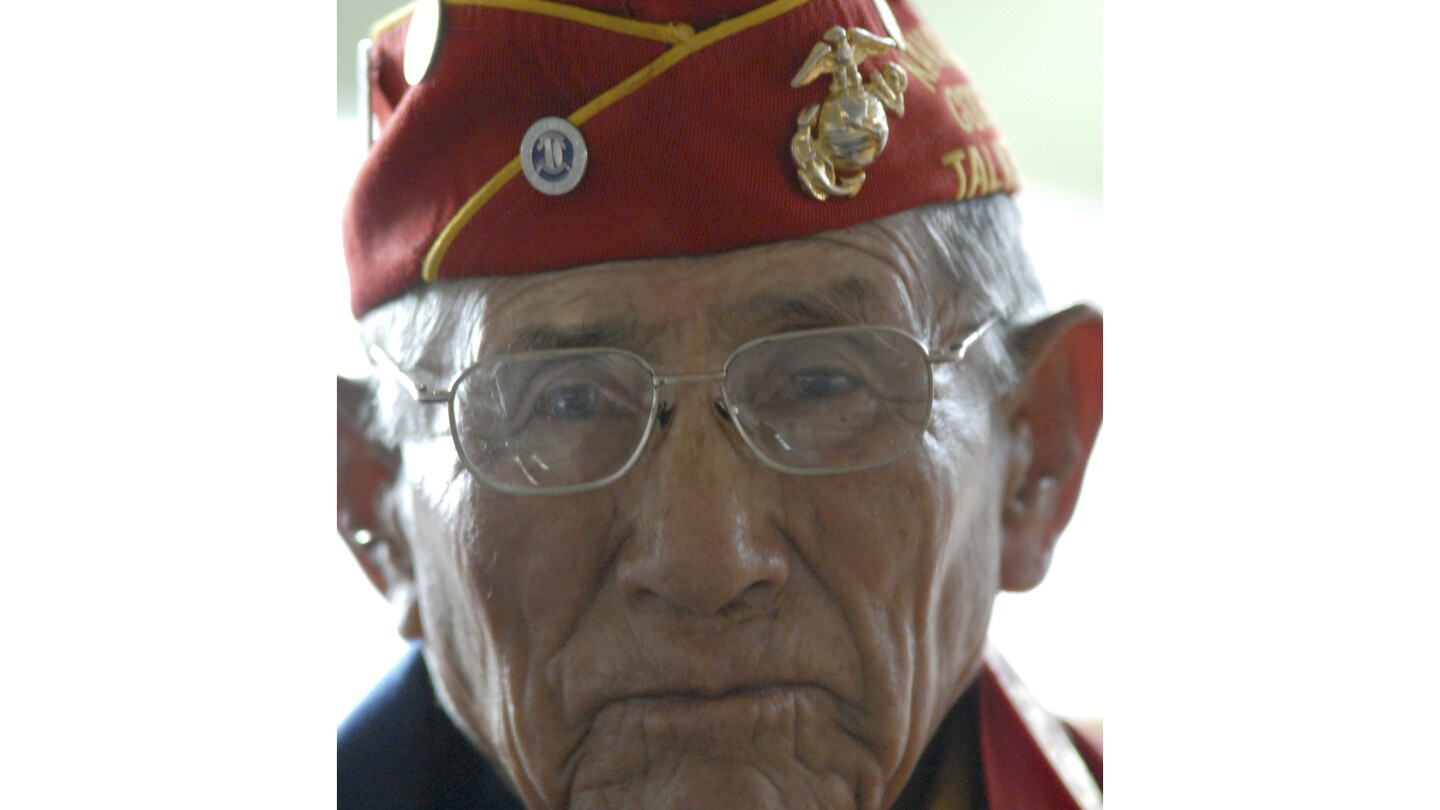 FILE - Navajo Code Talker John Kinsel Sr., of Lukachukai, Ariz., listens as his comrades speak of their WWII experiences Tuesday Aug. 14, 2007, in Win