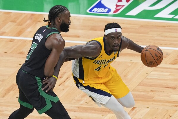 Indiana Pacers forward Pascal Siakam, right, is defended by Boston Celtics guard Jaylen Brown (7) during the second half of Game 2 of the NBA Eastern Conference basketball finals Thursday, May 23, 2024, in Boston. (AP Photo/Michael Dwyer)