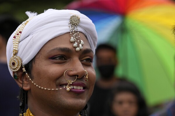 A participant smiles during an annual pride parade in Mumbai, India, Saturday, June 24, 2023. (AP Photo/Rajanish Kakade)