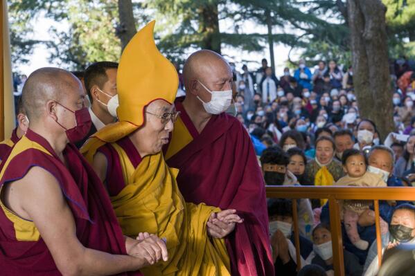 Tibetan spiritual leader the Dalai Lama in a ceremonial yellow hat arrives at the Tsuglakhang temple to give a sermon in Dharamsala, India, Tuesday, March 7, 2023. The Dalai Lama apologized Monday, April 10, after a video showing him kissing a child on the lips at a public gathering in February provoked outrage. (AP Photo/Ashwini Bhatia, File)