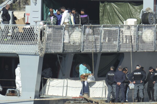 Migrants disembark an Italian Navy ship, as Italy sent 49 people to Albania for processing following earlier court rejections to Albania, in Shengjin, northwestern Albania, Tuesday, Jan. 28, 2025. (AP Photo/Vlasov Sulaj, File)