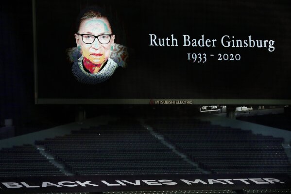A memorial to late Supreme Court Justice Ruth Bader Ginsburg is displayed at Fenway Park before a baseball game between the Boston Red Sox and the New York Yankees, Saturday, Sept. 19, 2020, in Boston. (AP Photo/Michael Dwyer)