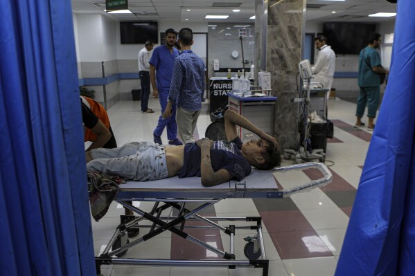 FILE - A wounded Palestinian boy arrives to the emergency room of the al-Shifa hospital, following Israeli airstrikes on Gaza City, central Gaza Strip, Tuesday, Oct. 17, 2023. Gaza's Shifa Hospital has become the focus of a days-long stalemate in Israel's war against Hamas. Israel claims Hamas uses the facility for military purposes and has built a vast underground command center below the hospital. Since Israel declared war against Hamas, its forces have moved in on Shifa. But hundreds of doctors and patients remain inside. (AP Photo/Abed Khaled, File)