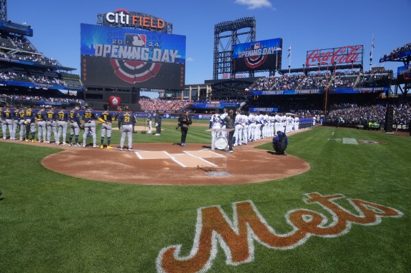 Players line up for opening day ceremonies before a baseball game between the New York Mets and the Milwaukee Brewers Friday, March 29, 2024, in New York. (AP Photo/Frank Franklin II)