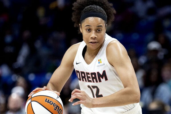 FILE - Atlanta Dream forward Nia Coffey controls the ball during a WNBA basketball game against the Dallas Wings, May 7, 2022, in Arlington, Texas. Coffey will miss the remainder of the 2023 season with a left hand injury. (AP Photo/Brandon Wade, File)