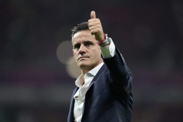 FILE - Canada's head coach John Herdman gestures at the end of the World Cup group F soccer match between Belgium and Canada, at the Ahmad Bin Ali Stadium in Doha, Qatar, Wednesday, Nov. 23, 2022. Herdman quit as coach of Canada's men's national team on Monday, Aug. 28, 2023, to move behind the bench at Toronto of Major League Soccer starting Oct. 1. (AP Photo/Natacha Pisarenko, File)