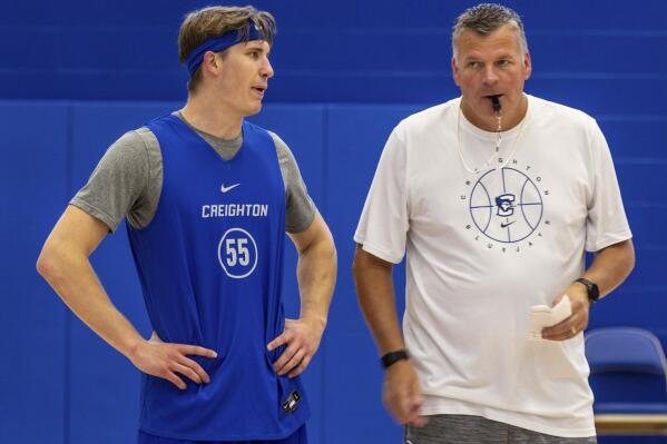Creighton's Baylor Scheierman, left, talks with coach Greg McDermott during the NCAA college basketball team's practice Tuesday, Oct. 11, 2022, in Omaha, Neb. Scheierman is in his first year at Creighton after transferring from South Dakota State. (Chris Machian/Omaha World-Herald via AP)