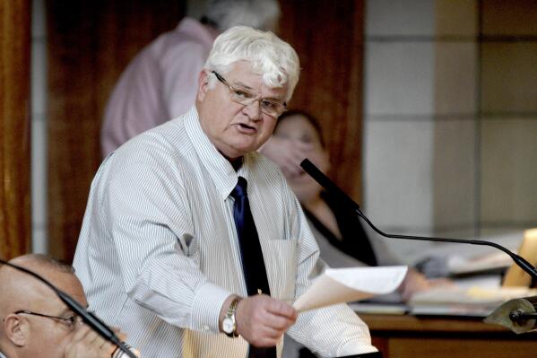 FILE - Neb. Sen. Mike Groene of North Platte holds up a spreadsheet as he speaks in Lincoln, Neb., Wednesday, Feb. 19, 2020. Nebraska state Sen. Mike Groene denied accusations Friday, Feb. 18, 2022 that he took inappropriate photos of a female legislative aide without her knowledge, but he said he was going to resign next week to avoid putting his family through a public ordeal. (AP Photo/Nati Harnik, File)