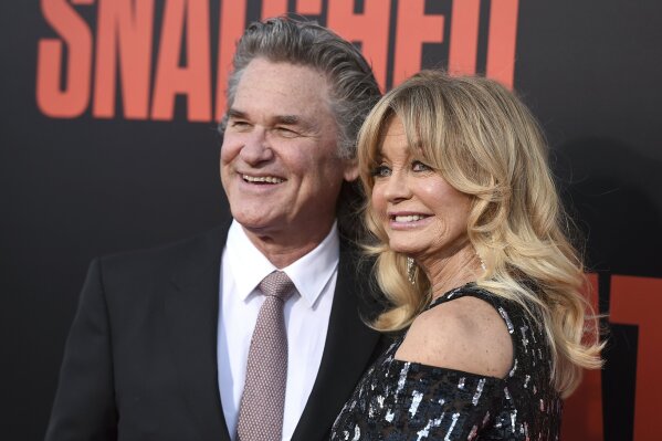 FILE - Kurt Russell, left, and Goldie Hawn appear at the premiere of Hawn's film, "Snatched" in Los Angeles on May 10, 2017. Russell and Hawn star in the holiday film "The Christmas Chronicles: Part Two," premiering Friday on Netflix. (Photo by Jordan Strauss/Invision/AP, File)