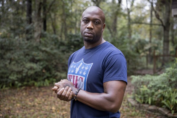 Former NFL player Boo Williams poses for a portrait outside of his home in Picayune, Miss., Wednesday, Nov. 15, 2023. Williams needs surgery, medicine and doctors to make the pain subside from injuries he endured during his football career. But he can't afford any of it. The 44-year-old was recently awarded $5,000 a month by the NFL's disability benefit plan. But Williams said the plan and the league have repeatedly mishandled his claims and should really have paid him $500,000 or more over the past 14 years. (AP Photo/Christiana Botic)