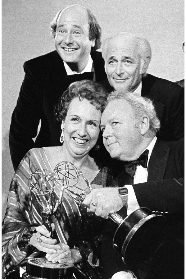 Actors Jean Stapleton, seated, left, and Carroll O'Connor, seated, right, hold their Emmys for “All in the Family” after receiving them on Sept. 18, 1978, in Los Angeles. At rear, from left to right are Rob Reiner, who won an Emmy for supporting actor in the same series; Norman Lear, producer of the show; and executive producer Mort Lachman. (AP Photo, File)